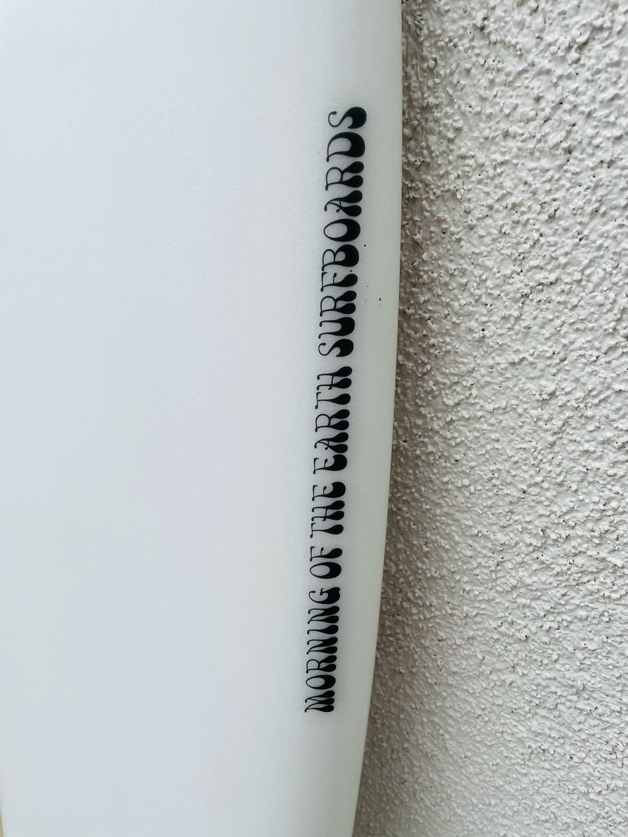 Morning Of The Earth | 5'6” Tracks Twinny Clear Surfboard (USED) Morning Of The Earth | 5'6” Tracks Twinny Clear Surfboard (USED)